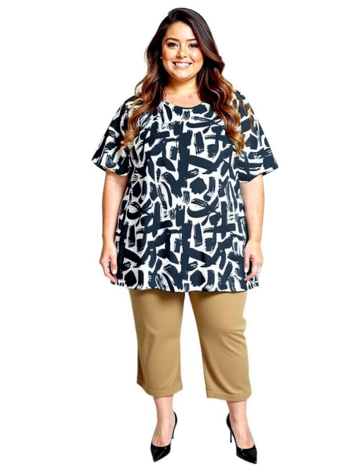 Woman wearing Love Is In The Air Pants - Coco Truffle with a stylish black and white top, showcasing plus size fashion.