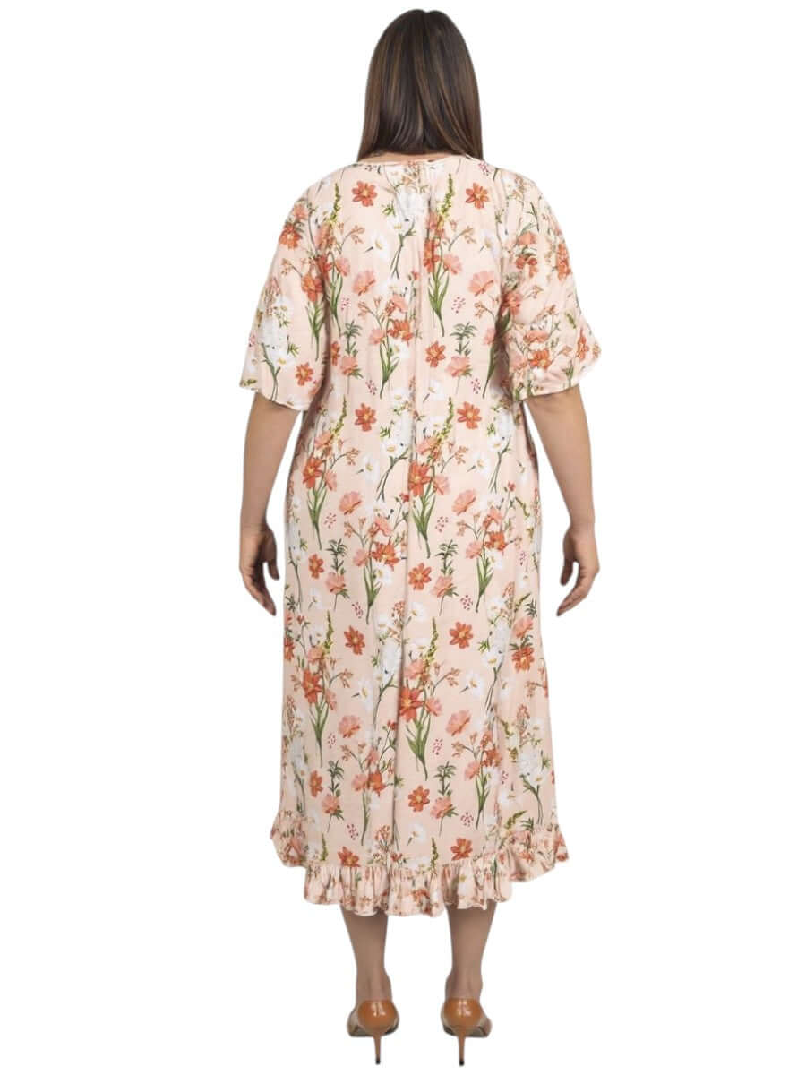 Back view of women’s plus size Trinity Dress in apricot print by Dale and Waters, featuring a ruffled hem and short sleeves.