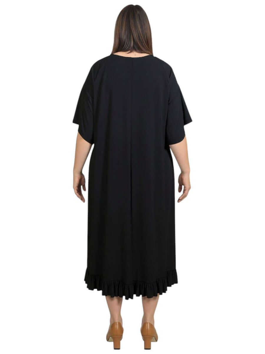 Back view of the Women’s Plus Size Trinity Dress in Black by Dale and Waters, featuring a ruffled hem and relaxed fit.