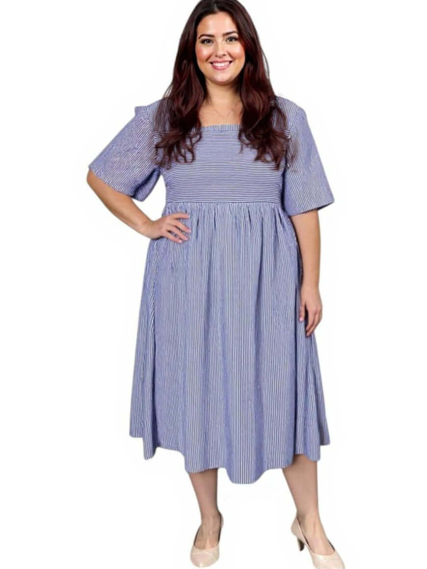 Plus size women’s August Dress by Dale and Waters in blue print with square neckline and short sleeves.