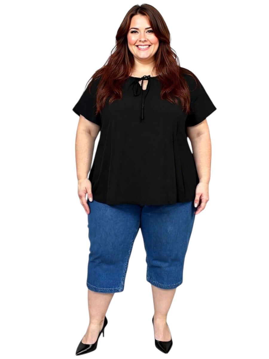 Women’s Plus Size Yasmin Top in Black by Dale and Waters, featuring a keyhole neckline and flutter sleeves, styled with denim.