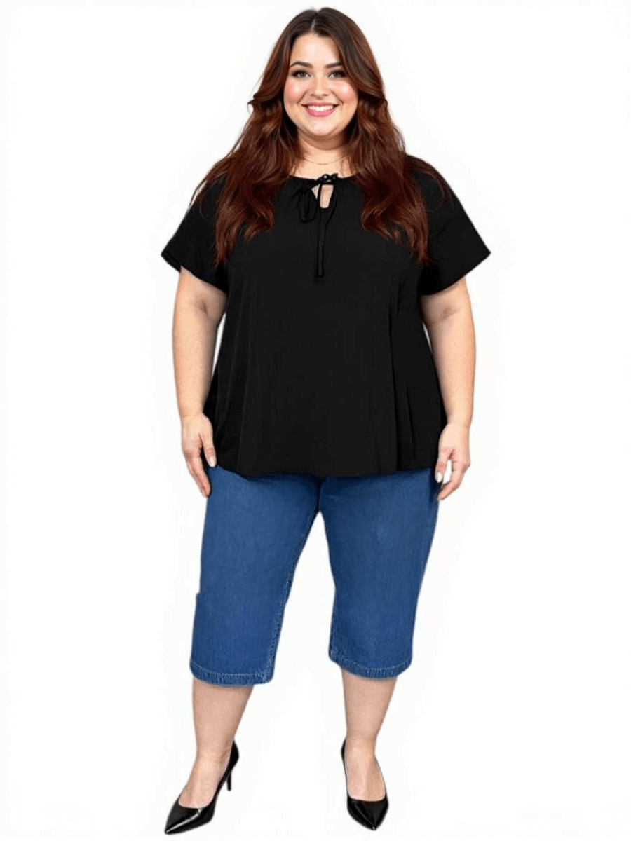Women’s Plus Size Yasmin Top in black with keyhole tie and flutter sleeves, styled with denim capris.