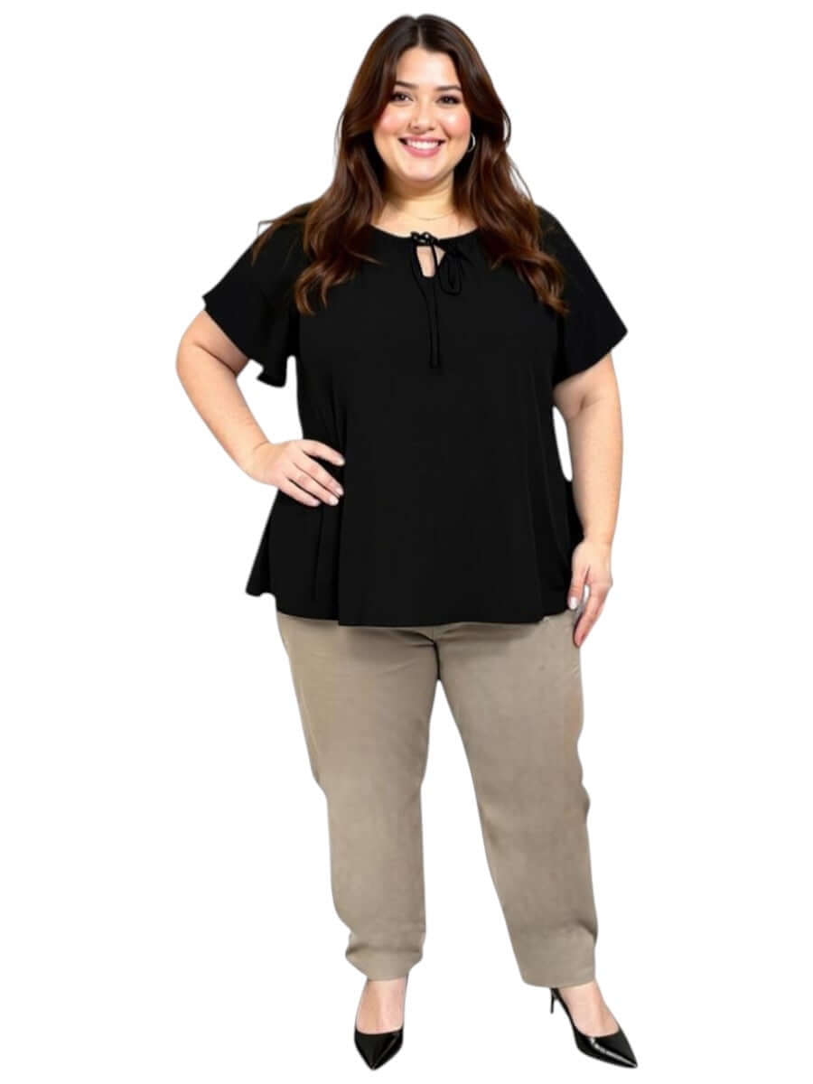 Women’s Plus Size Yasmin Top in black with flutter sleeves and keyhole tie, styled with beige pants by Dale and Waters.