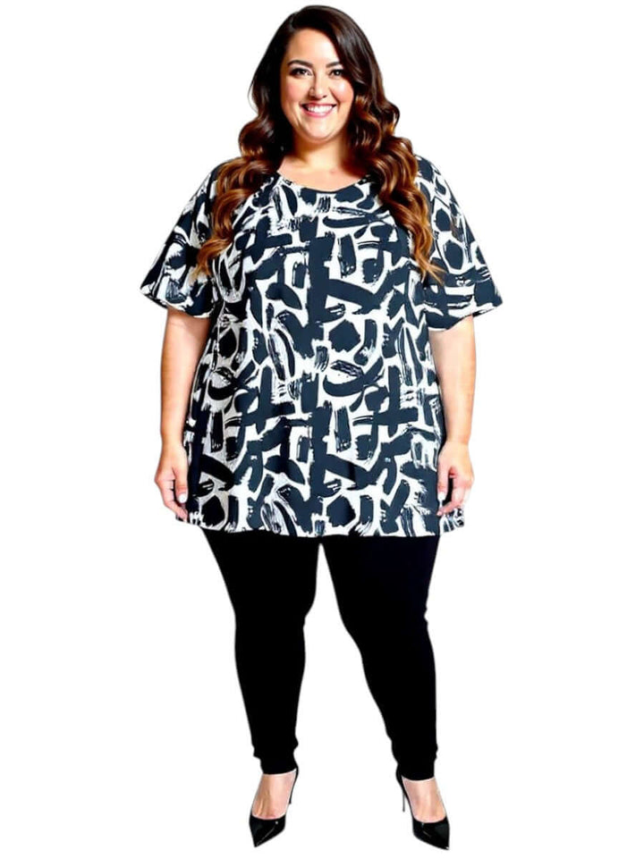 Women’s Plus Size Johanna Top in black and cream print by Dale and Waters, styled with black pants for a chic casual look.