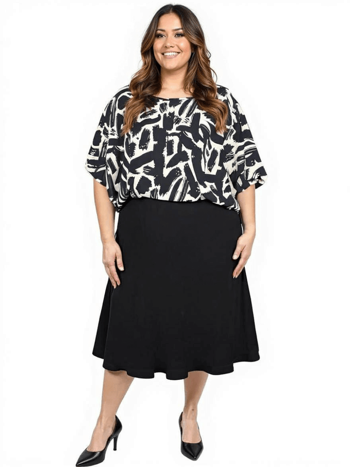 Women’s Plus Size Johanna Top in black and cream print styled with a black skirt for a chic look by Dale and Waters.