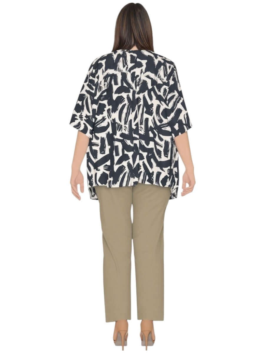 Back view of the Women’s Plus Size Johanna Top in black and cream print, paired with khaki pants.
