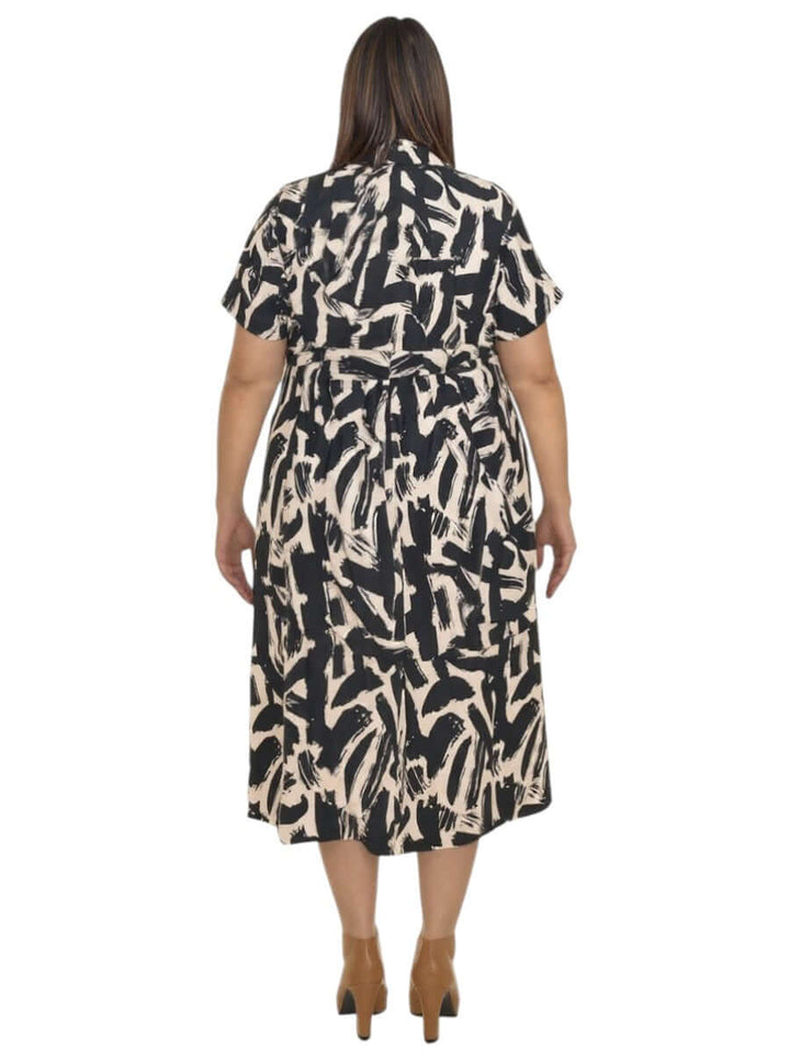 Back view of Women’s Plus Size Johanna Dress in Black and Cream Print by Dale and Waters, featuring a babydoll cut with flowing sleeves.