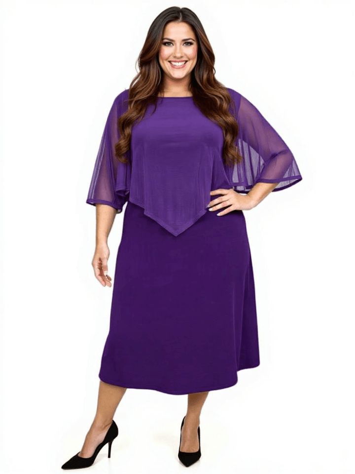 Plus size woman wearing a classic sleeveless mulberry silk dress with an elegant extended shawl collar in deep purple.