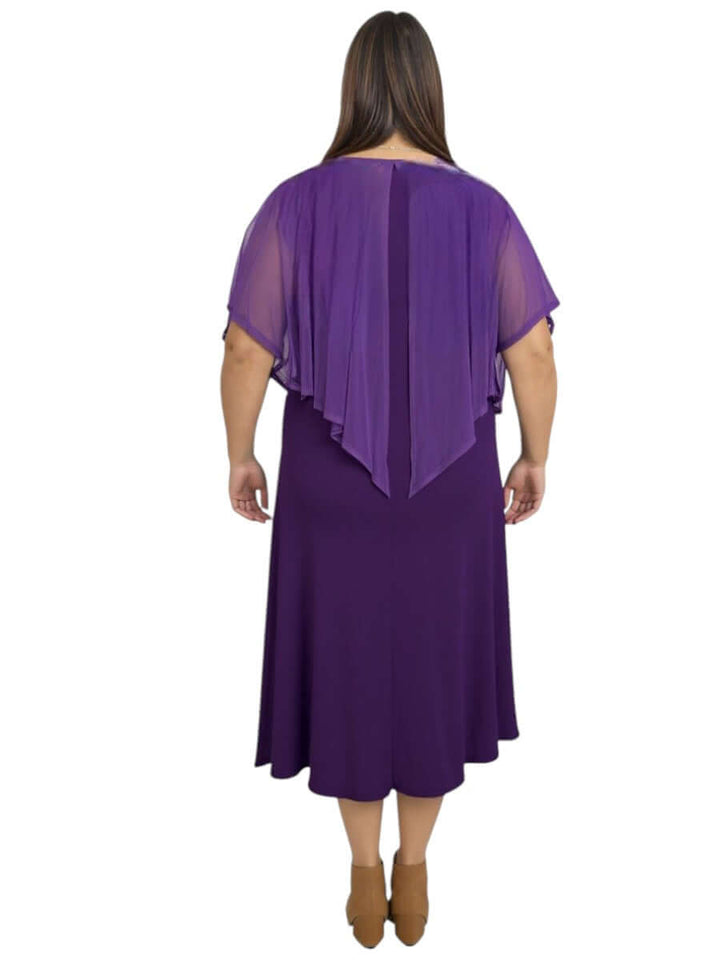 Back view of a plus size woman in a classic sleeveless mulberry silk dress with an elegant shawl collar.