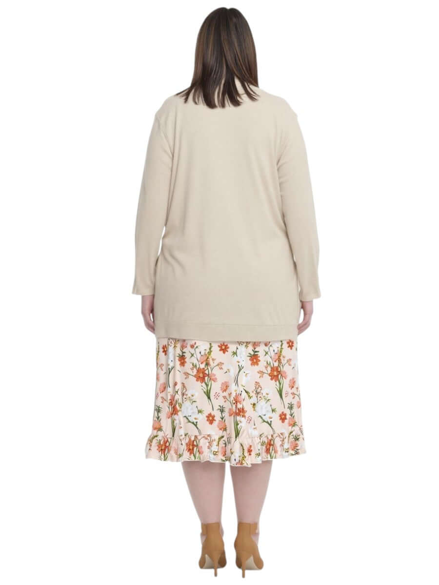 Back view of plus size women's Mercedes E2E Cardi in Stone by Dale and Waters, paired with floral skirt.