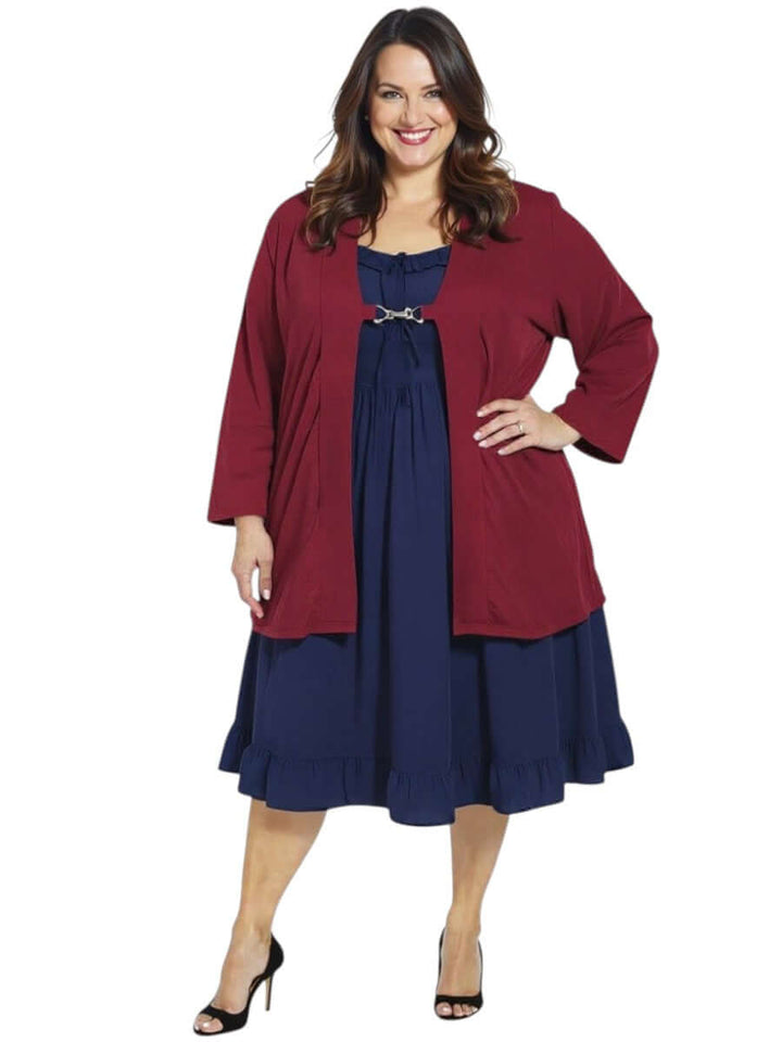 Lady wearing a plus size wine edge-to-edge cardigan over a navy dress, showcasing a stylish and lightweight look by Dale and Waters