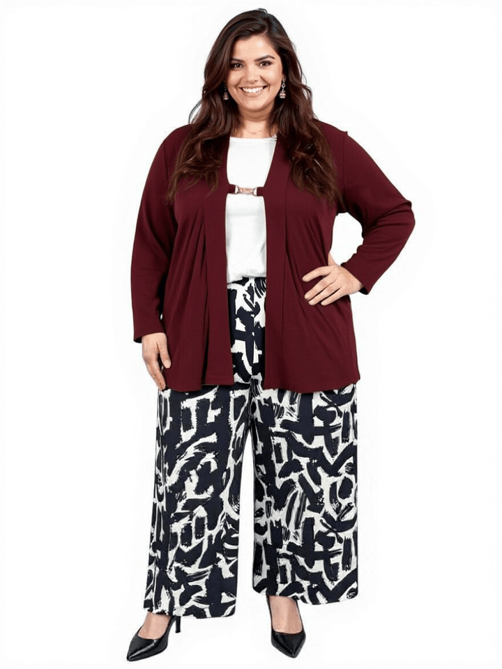 Plus size woman wearing a wine-colored Mercedes E2E cardigan with patterned wide-leg pants.