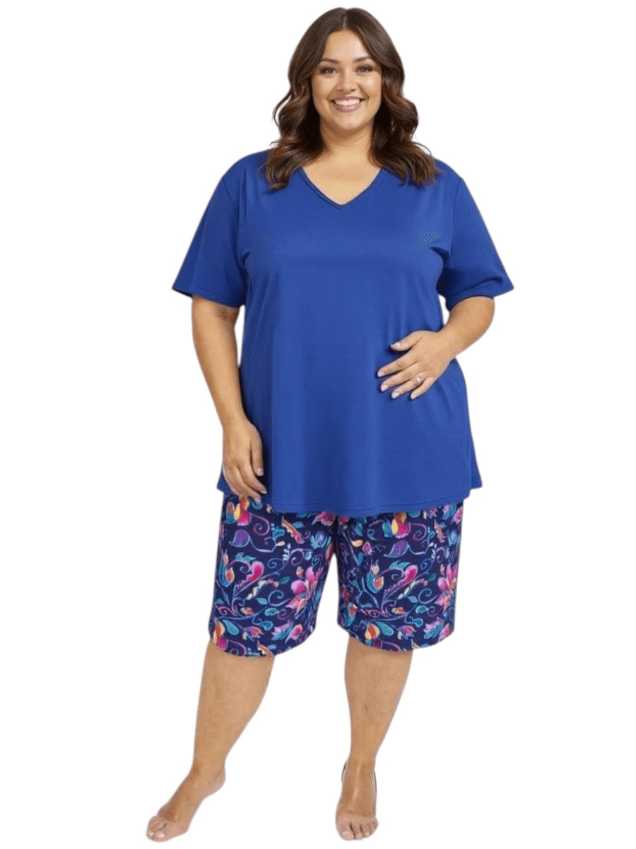Women’s Plus Size Deep Sea Swim Rashi by Dale and Waters in blue, featuring a V-neck and colorful patterned shorts.