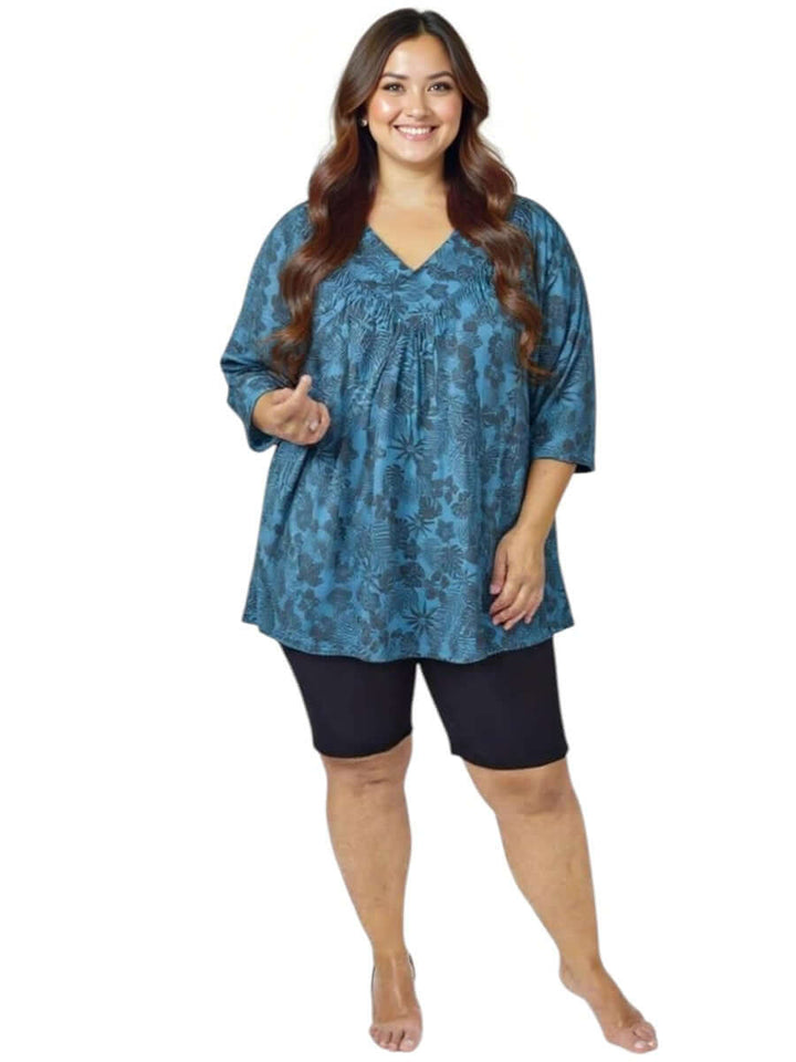 Women’s Plus Size Shadow Tropics Swim Rashi in teal print by Dale and Waters, showcasing V-neckline and ¾ sleeves.