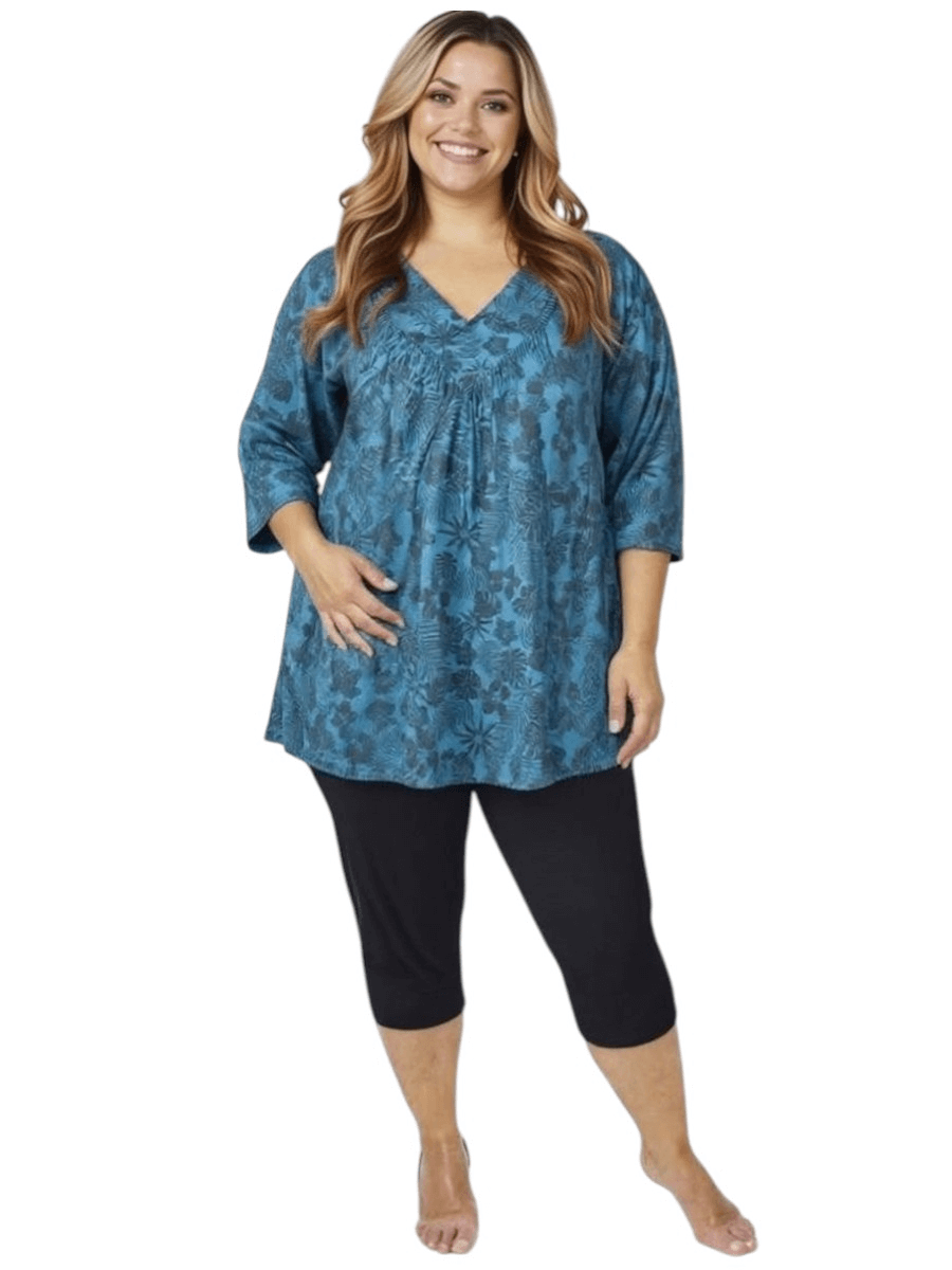 Women’s Plus Size Shadow Tropics Swim Rashi in teal print, featuring a V-neckline and ¾ sleeves, by Dale and Waters.