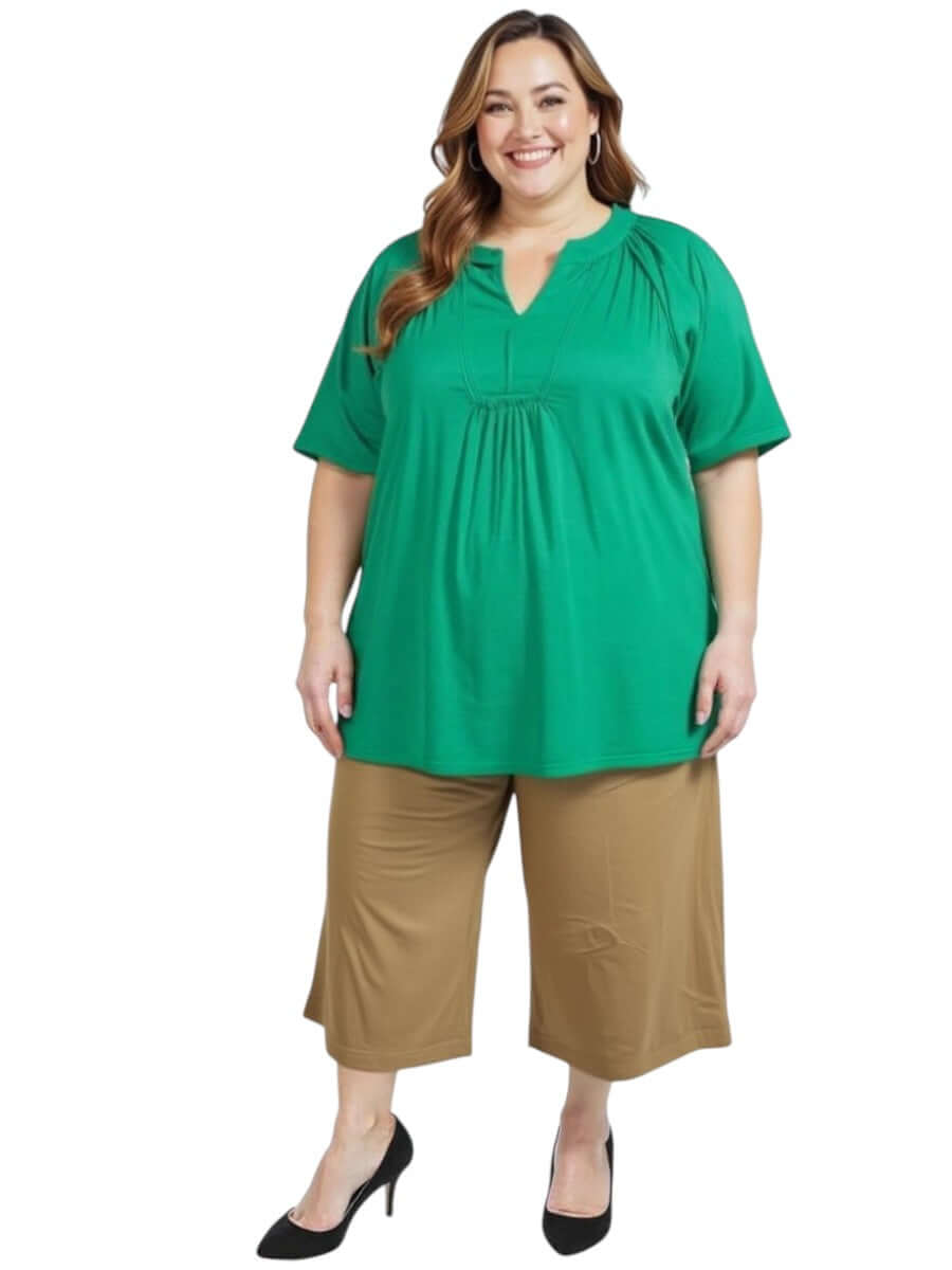 Woman wearing Love Is In The Air Pants - Coco Truffle with green top, plus size fashion for sizes 16-50 by Dale & Waters.