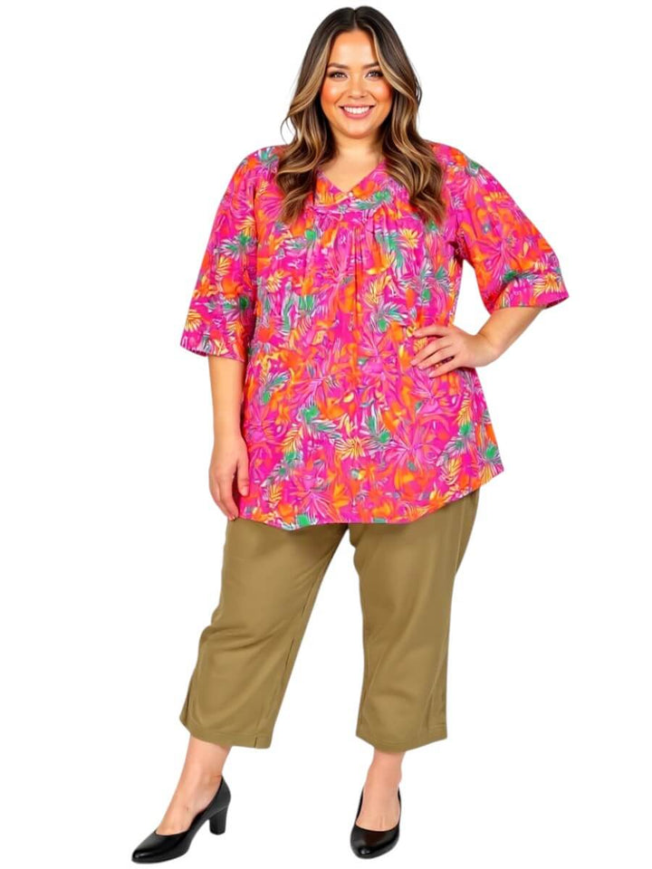 Plus size women modeling Love Is In The Air Pants - Coco Truffle with a colorful floral top.