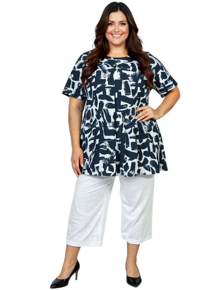 Woman wearing Love Is In The Air Pants - White with a stylish printed top, showcasing plus size fashion.