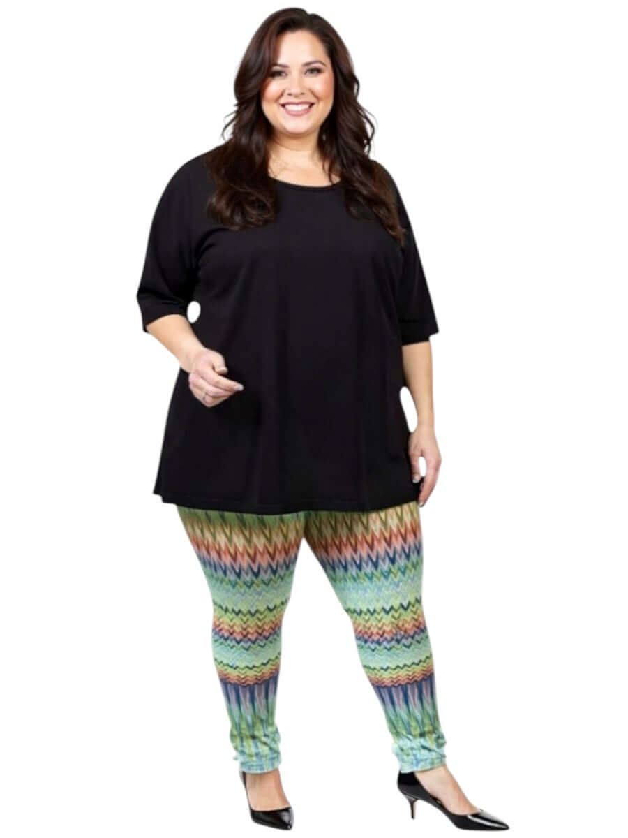 Women wearing Atlas Leggings - Multi Print with a black top, showcasing plus size fashion and vibrant patterns.