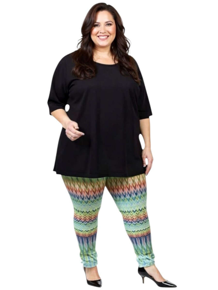 Women wearing Atlas Leggings - Multi Print with a black top, showcasing plus size fashion and vibrant patterns.