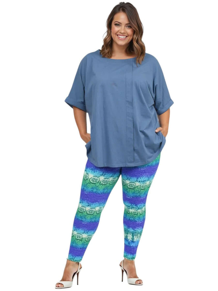 Atlas Leggings - Purple Print styled with a blue top on a plus size model, showcasing comfort and vibrant design.