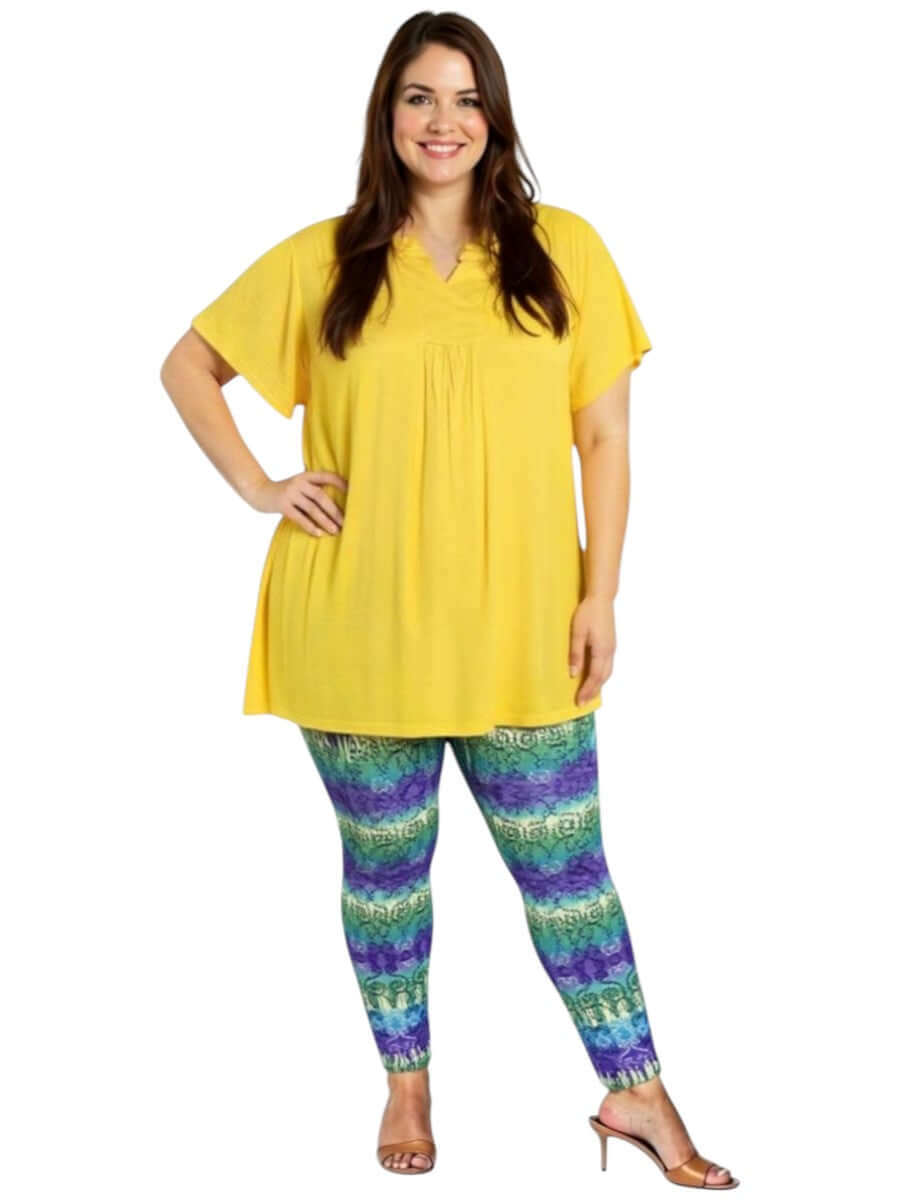 Woman wearing plus size Atlas Leggings - Purple Print with a yellow top, showcasing style and comfort.