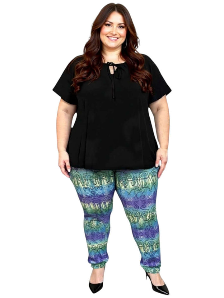 Woman wearing Atlas Leggings - Purple Print with a black top, showcasing plus size comfort and style.