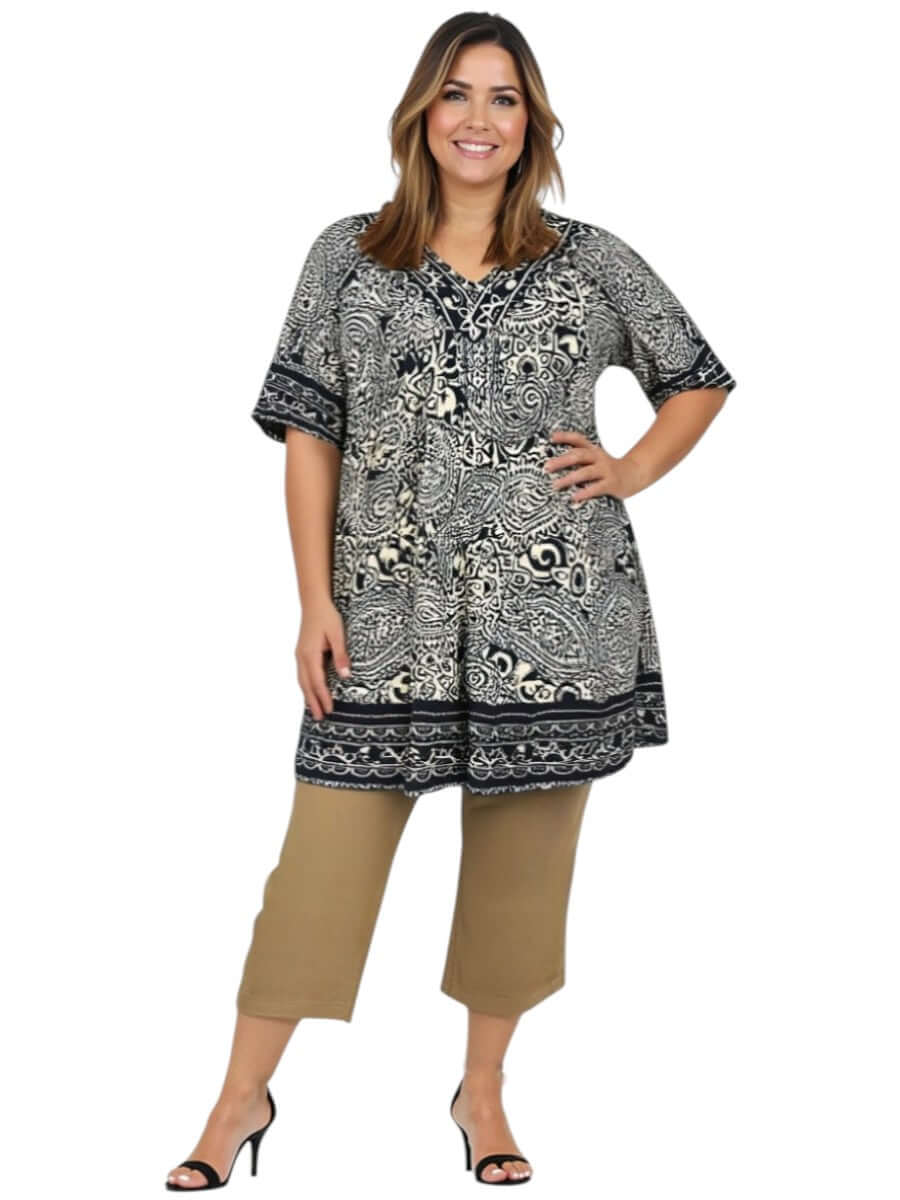 Women’s plus size model wearing Love Is In The Air Pants - Coco Truffle with a stylish patterned top.