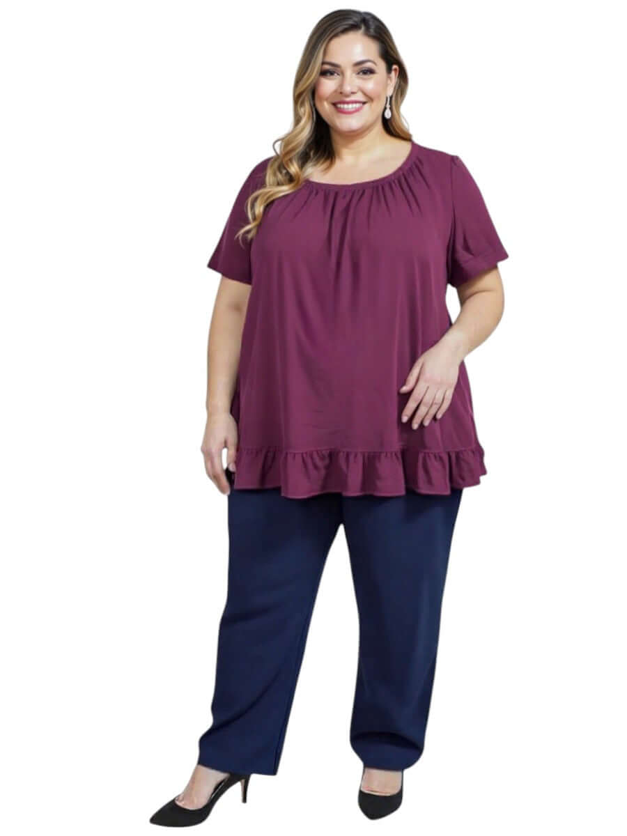 Women’s Plus Size Landra Top - Plum with flutter sleeves and ruffled hem, styled with navy pants for a chic summer look.