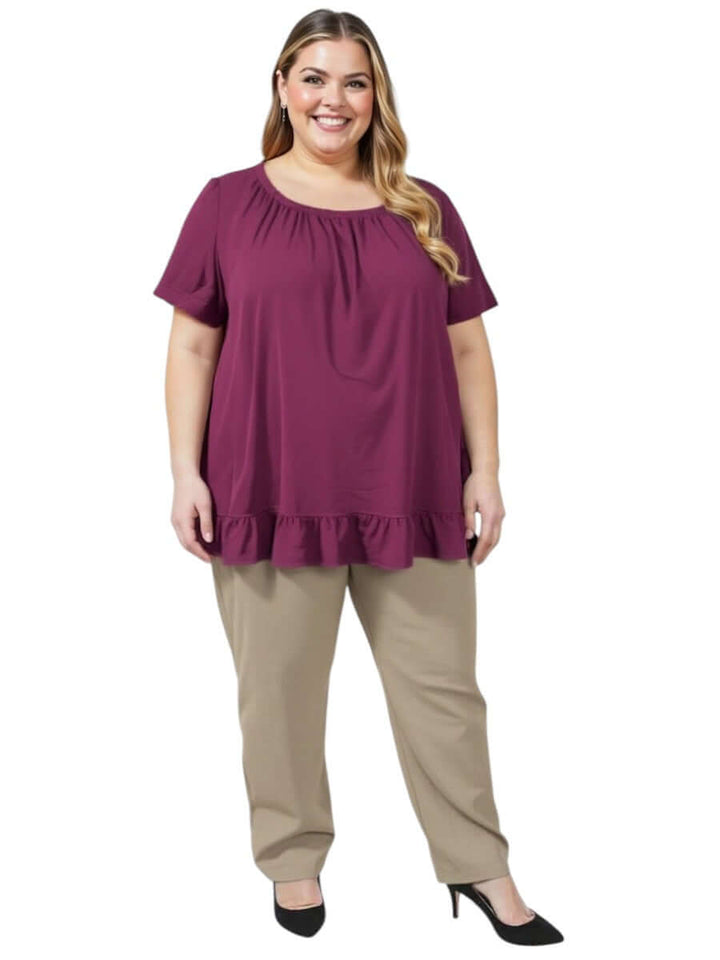 Women’s Plus Size Landra Top - Plum with flutter sleeves and ruffle hem, paired with beige pants for summer style.