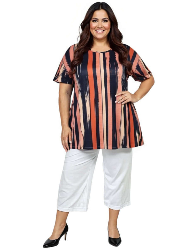 Women’s Plus Size Velma Top - Multi Print featuring vertical stripes, styled with white culottes and heels.