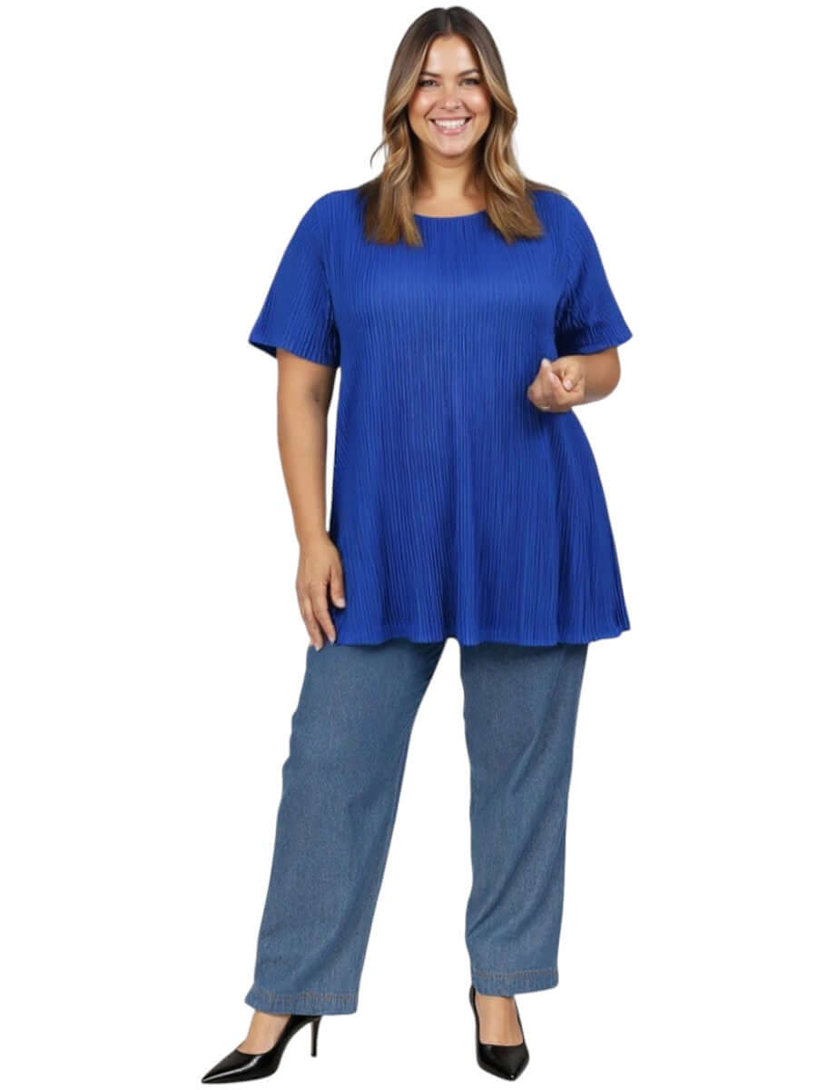 A model showcasing the Melany Top - Royal Blue, featuring a relaxed fit and pleated design paired with denim pants.
