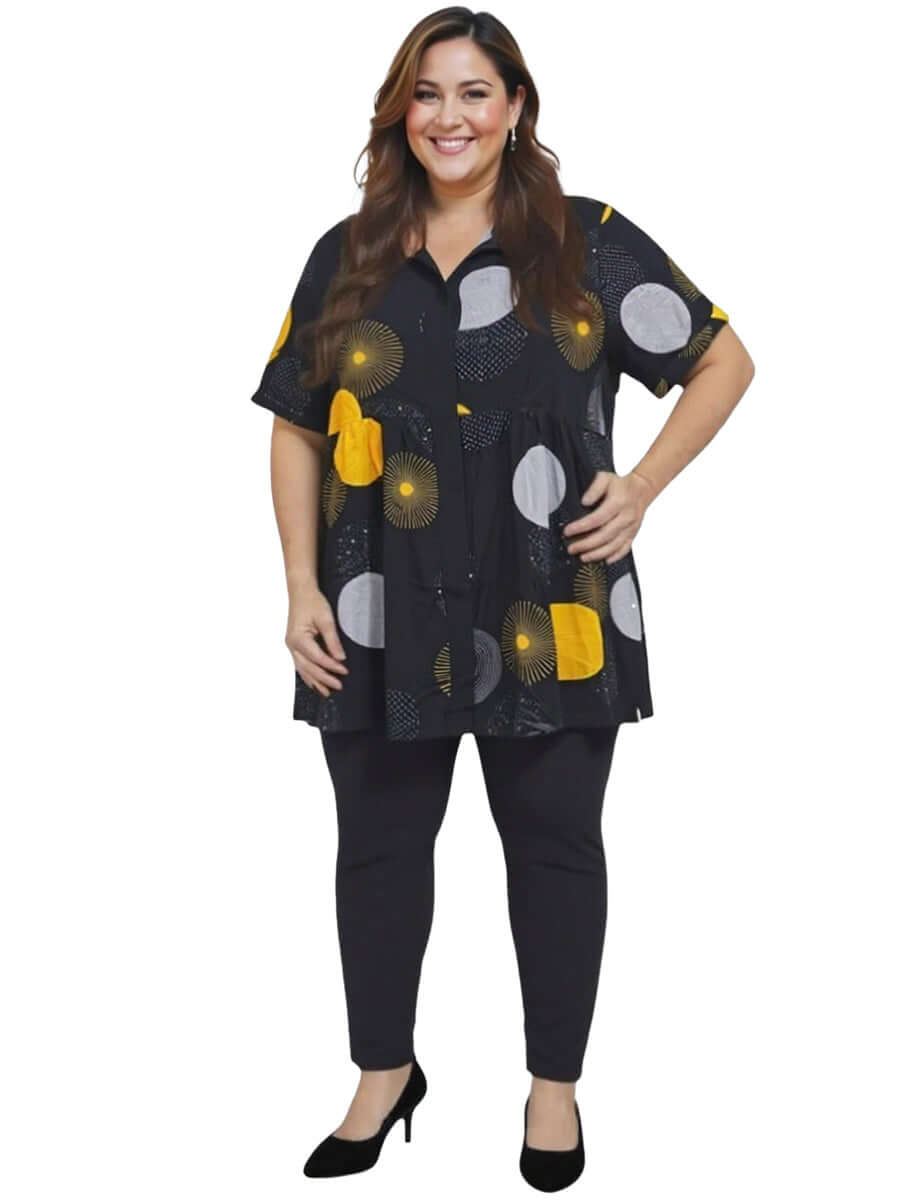 Coreen Tunic - Black Print worn by a plus-size model, featuring a babydoll silhouette and vibrant print for stylish comfort.