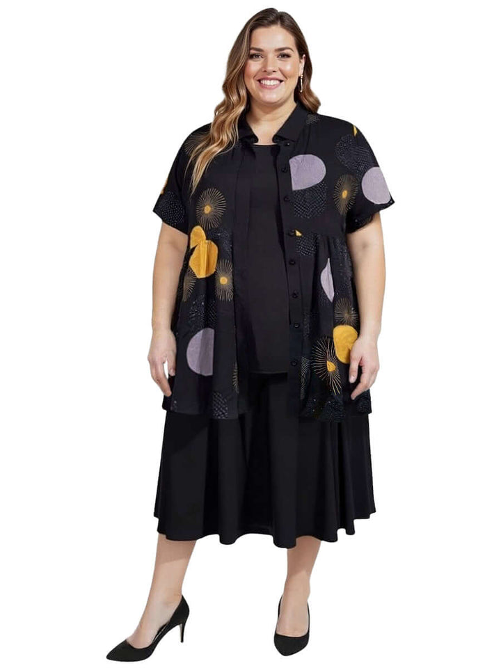 Coreen Tunic - Black Print worn by a plus-size woman, showcasing a lightweight, floaty babydoll blouse with a relaxed fit.