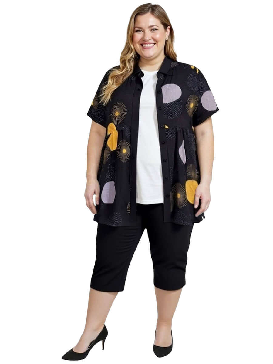 Coreen Tunic - Black Print worn by a plus-size woman, stylish design with colorful print, lightweight comfort for everyday wear.