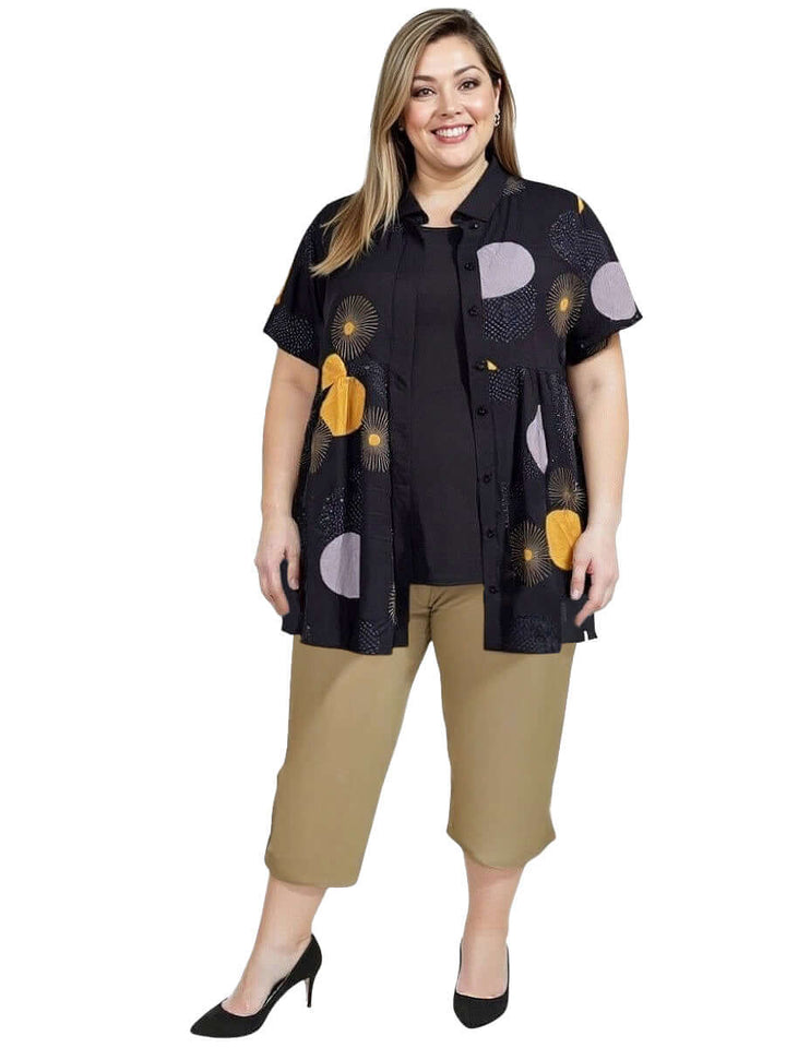 Coreen Tunic - Black Print worn by plus-size model, featuring a lightweight babydoll design with collared neckline and vibrant print.