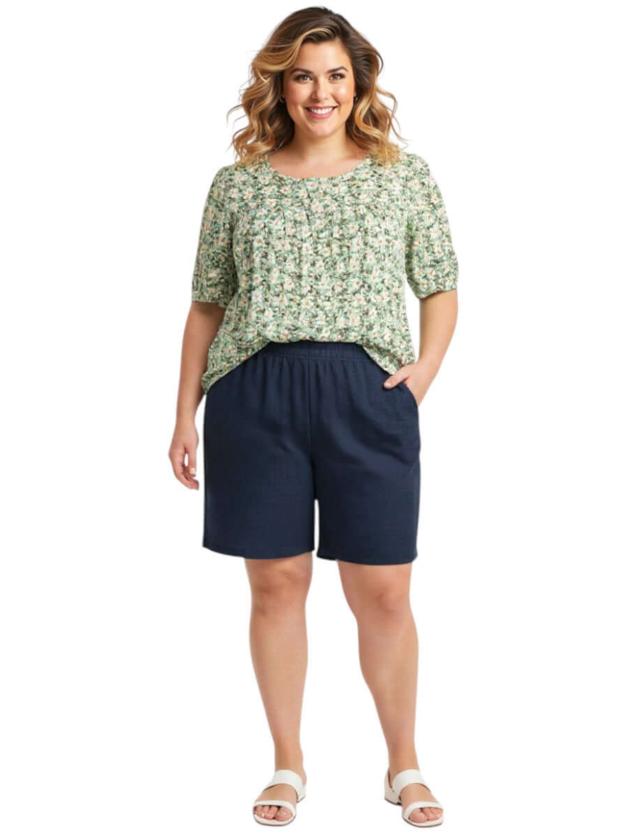 Mogan Bib Top - Green Print worn with navy shorts, showcasing women's plus size fashion from Dale and Waters.