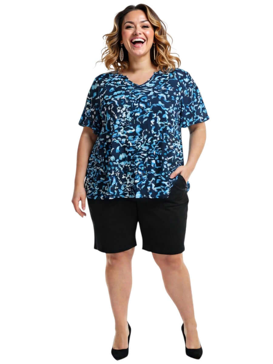 Ocean Top - Blue Print worn by a smiling woman in plus size, featuring a vibrant abstract design in shades of blue.