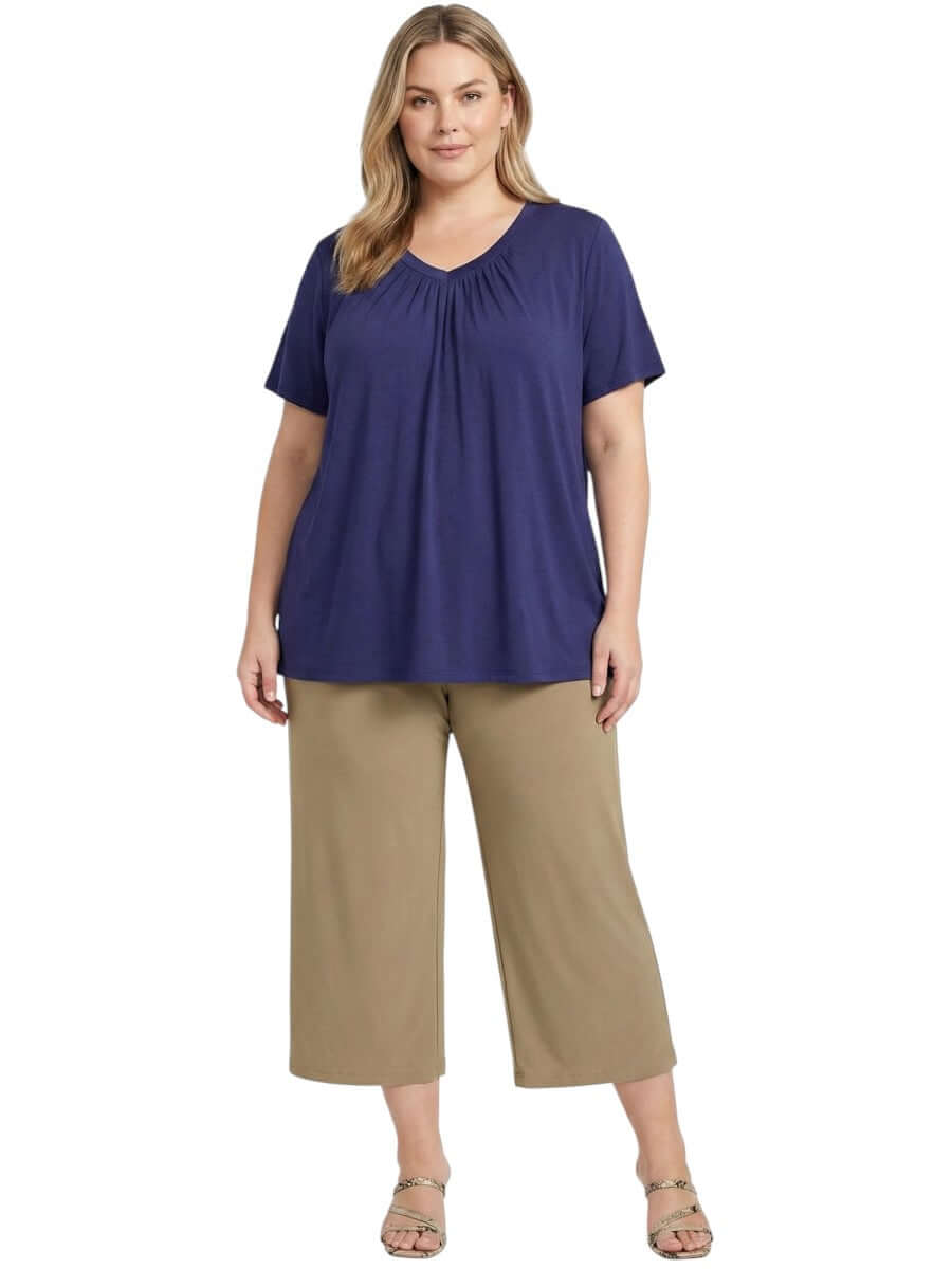 Women in plus size Montez Top - Blue styled with relaxed beige pants, showcasing modern women fashion.