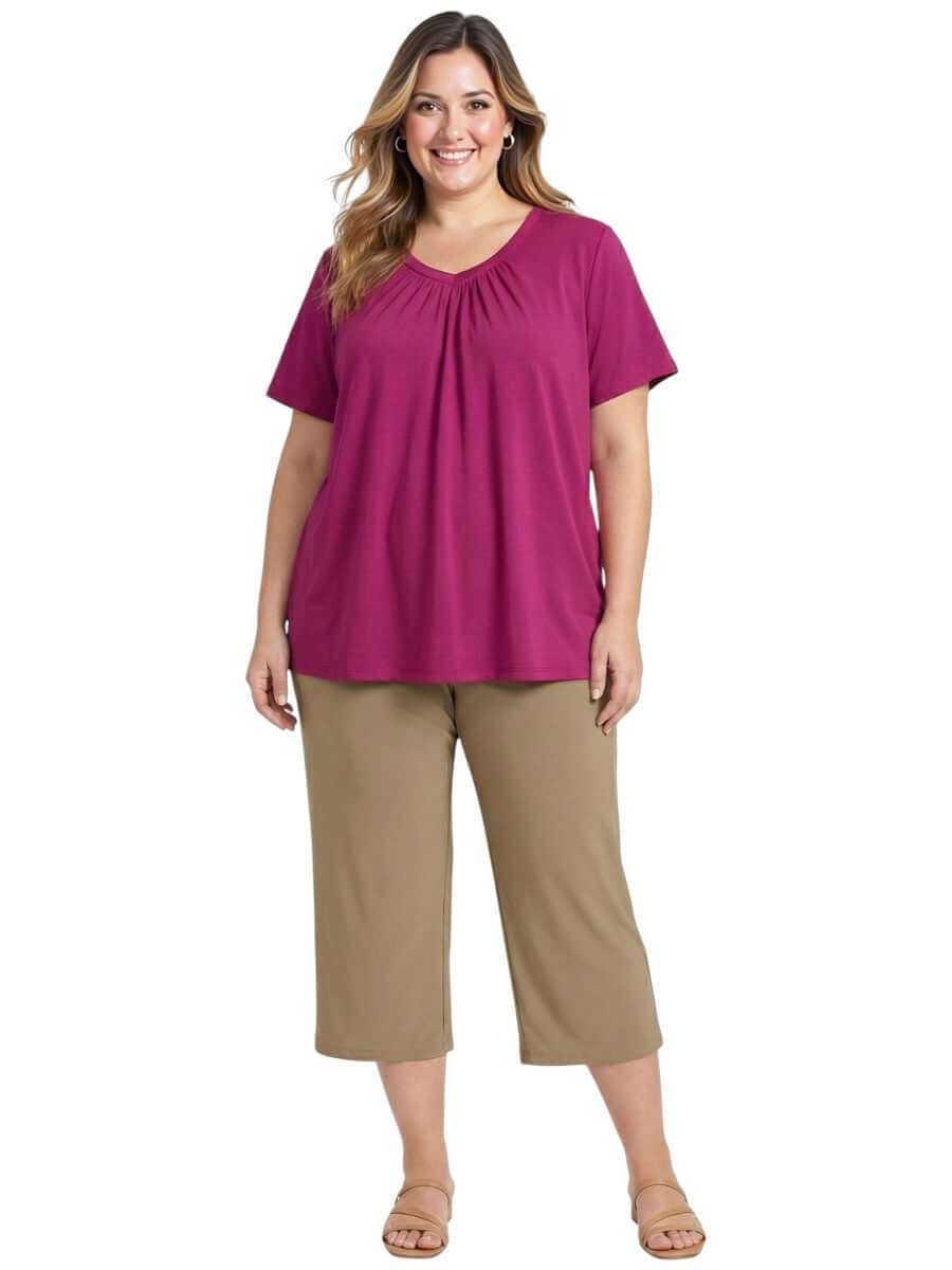 Plus size model wearing Montez Top - Pink with gathered V-neckline and breathable cotton fabric.