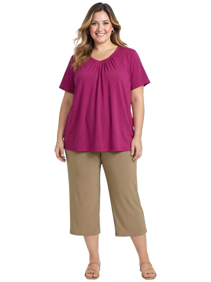 Plus size model wearing Montez Top - Pink with gathered V-neckline and breathable cotton fabric.