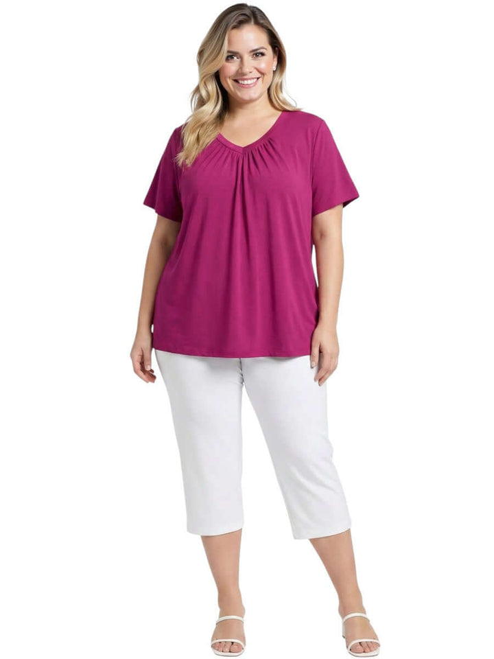 Women modeling Montez Top - Pink with gathered V-neckline and white pants, plus size fashion from Dale and Waters.