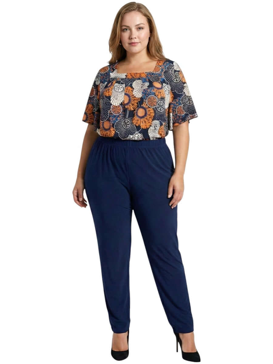 Lora Top - Navy Print on a plus-size model featuring floral patterns in navy, orange, and white.