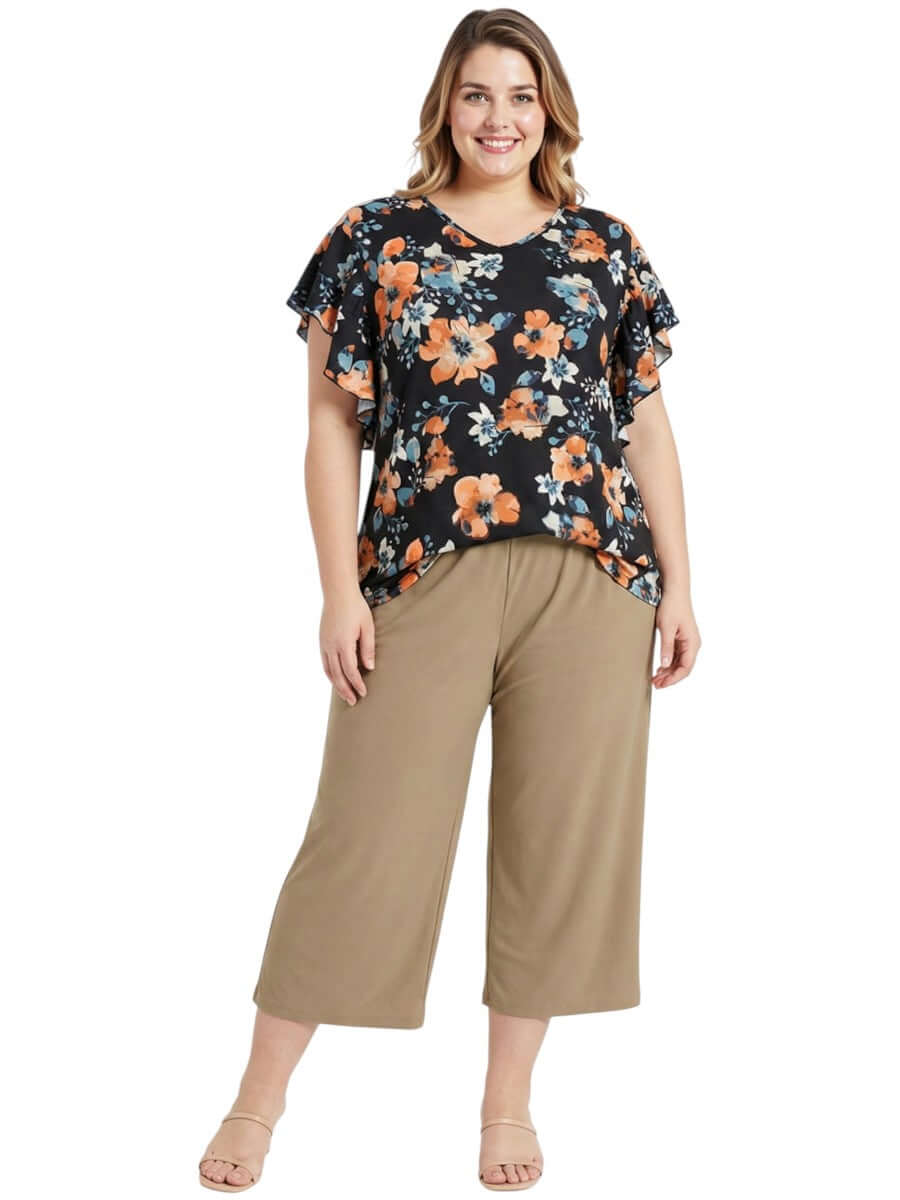 Kerissa Top - Black Print worn by a plus size woman, showcasing floral design in warm and earthy tones.