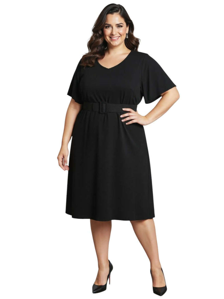 Women in Plus Size Westley Dress - Black showcasing a flattering V-neckline and flutter sleeves, stylish and elegant.