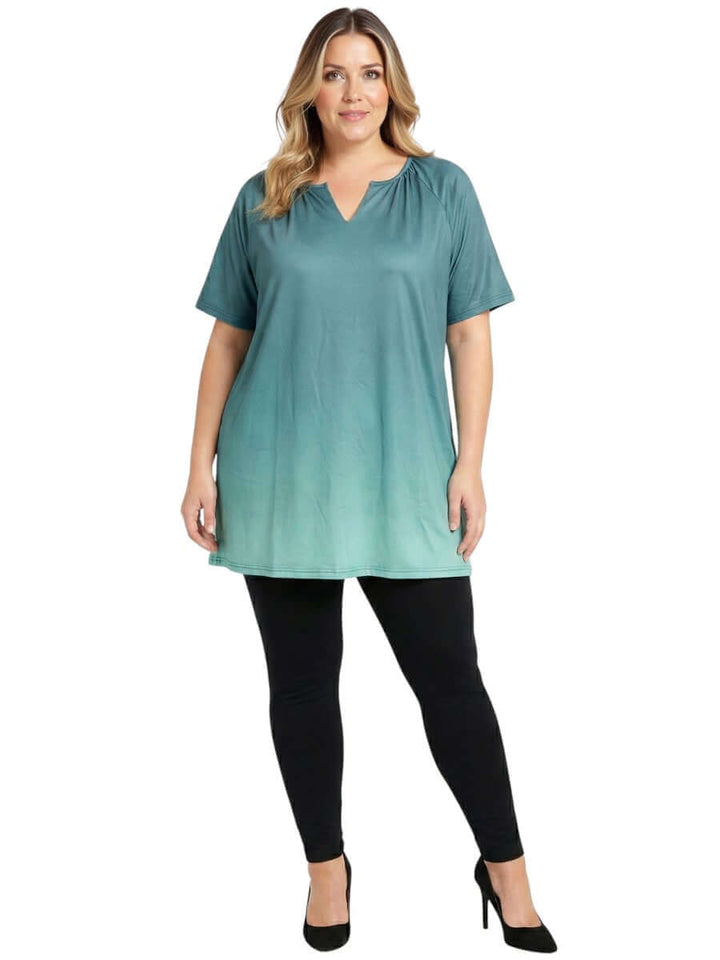 Icelynn Tunic - Teal Ombre model wearing a plus size teal ombre top paired with black leggings and heels.