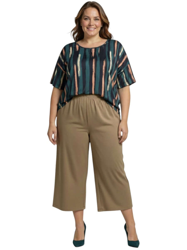 Velma Top - Green Print worn by a model, showcasing women's plus size fashion with a brushstroke pattern.