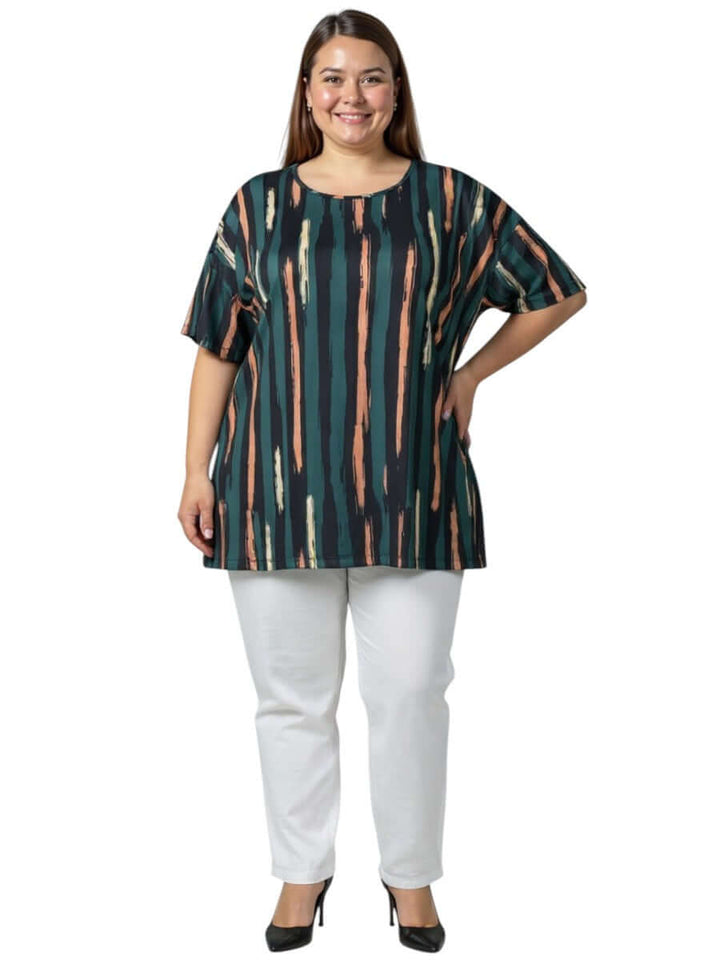 Velma Top - Green Print worn by a plus-size women, featuring a bold brushstroke stripe pattern in forest green with peach, cream, and navy.