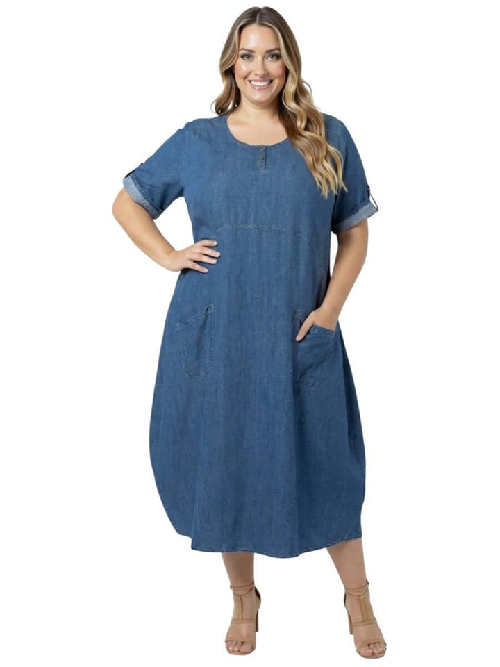 Women in plus size wearing Marino Denim Tensil Dress - Tensil with pockets and a modern tulip silhouette.