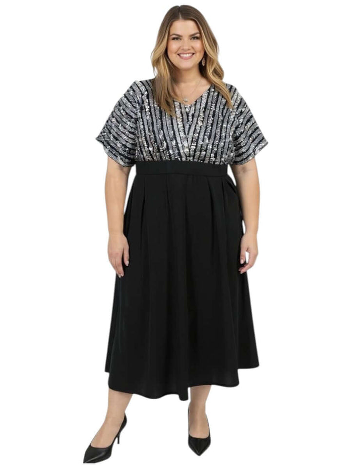 Plus Size Midnight Sonata Dress – Black by Dale and Waters, featuring a sequin bodice and elegant dolman sleeves.